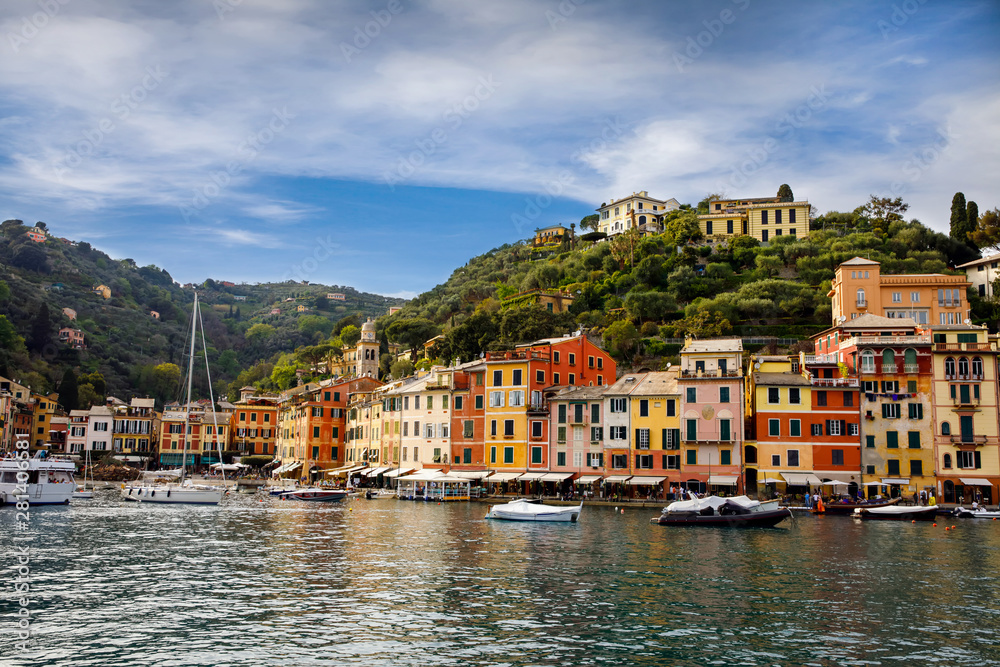 Beautiful small village Portofino with colorfull houses, luxury boats and yachts in little bay harbor. Liguria, Italy. On warm brigth summer day
