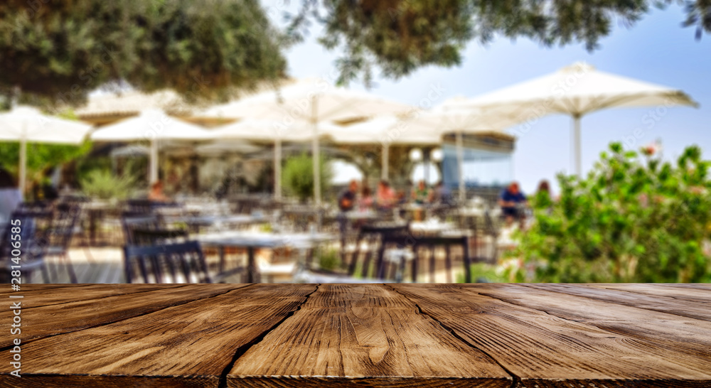 Restaurant background with wooden table top for an advertising product and decoration.