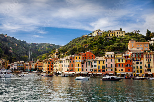 Beautiful small village Portofino with colorfull houses, luxury boats and yachts in little bay harbor. Liguria, Italy. On warm brigth summer day