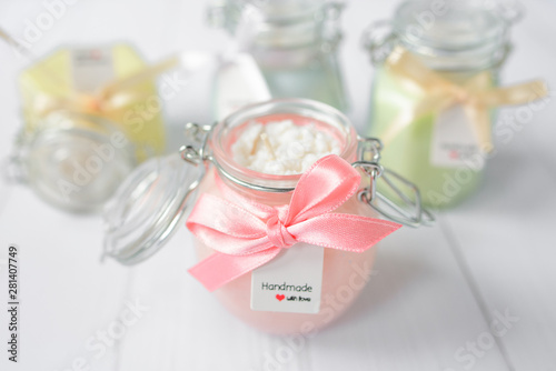 handmade light pink candles in glass jars, pastel colors