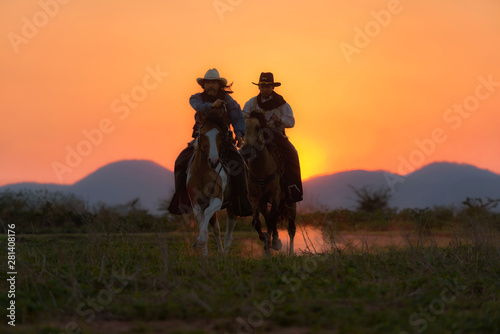 รหัสภาพถ่ายสต็อกปลอดค่าลิขสิทธิ์: 1466408231 Cowboys are riding horses silhouette in sunset with mountain scene in Pakchong, Nakhonratchasima, Thailand © weerachai