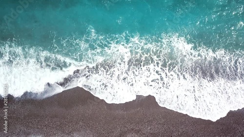 Aerial video from above of beautiful coastline and ocean waves near the tropical island beach. Holiday and vacation concept.