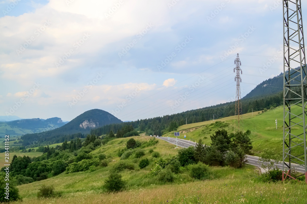 road stretches through summer forests, meadows and fields in rural landscape of Slovakia. road stretches through summer forests, meadows and fields in rural landscape of Slovakia.
