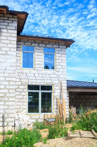 facade of cottage under construction with new inserted windows © sommersby