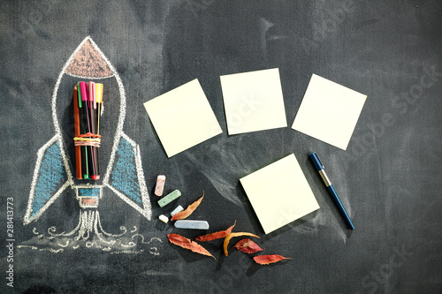 School blackboard background with some stationery and school supplies. Chalk drawing in white and colors.