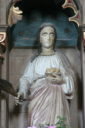 Saint Dorothea of Alexandria, statue on the altar of the Holy Family in the church of the Saint Nicholas in Lijevi Dubrovcak, Croatia photo