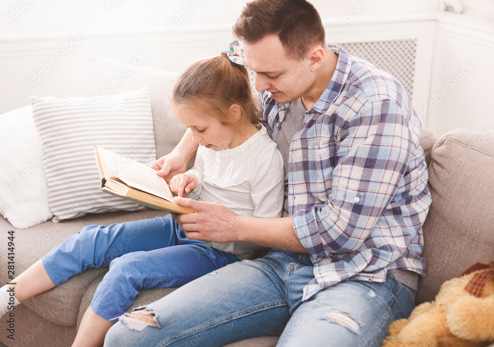 Little girl reading book with her dad Little girl reading book with her dad