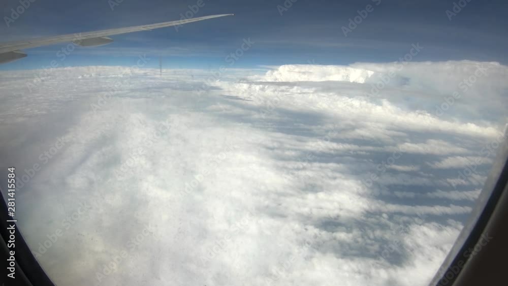 Airplane view flying over a strange formation of small and large clouds Airplane view flying over a strange formation of small and large clouds