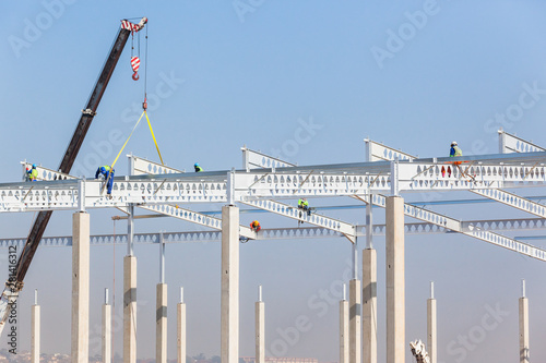 Construction Industrial Large Building Riggers Attaching High Roof  Steel Beams To ConcreteColumns