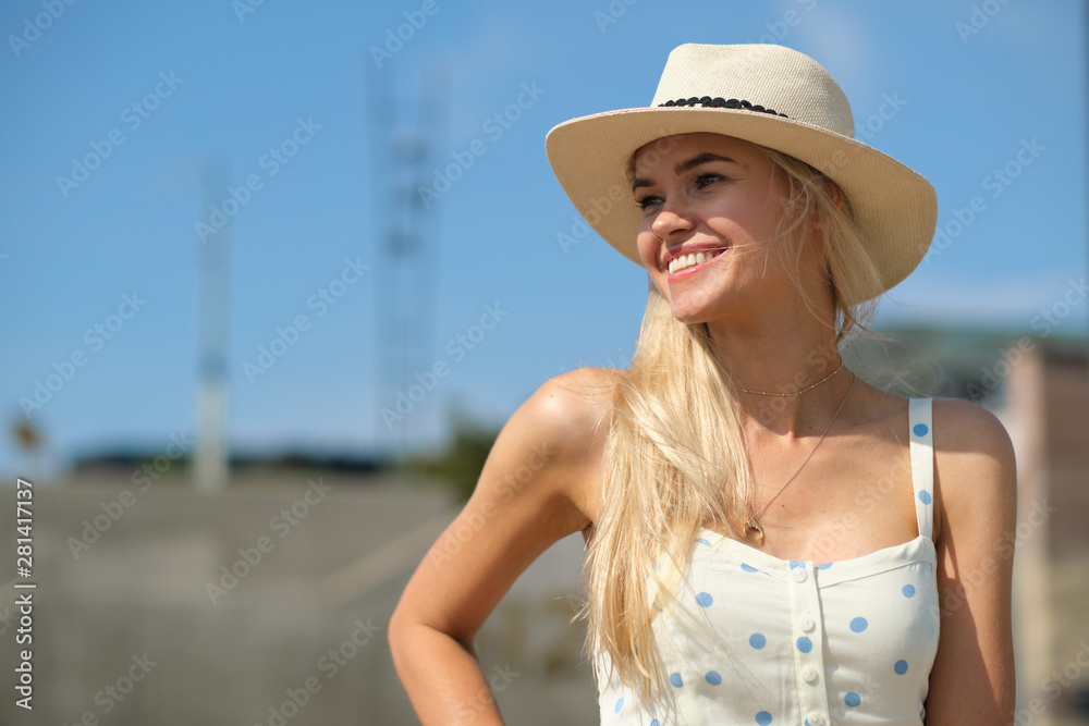 gorgeous beautiful woman in long white  dress and  hat walking.  Portrait of happy girl in the morning outdoors