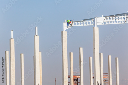 Construction Industrial Large Building Riggers Attaching High Roof Steel Beams To ConcreteColumns