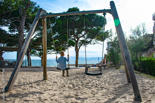 Child on a swing in the city of Salou. Spain