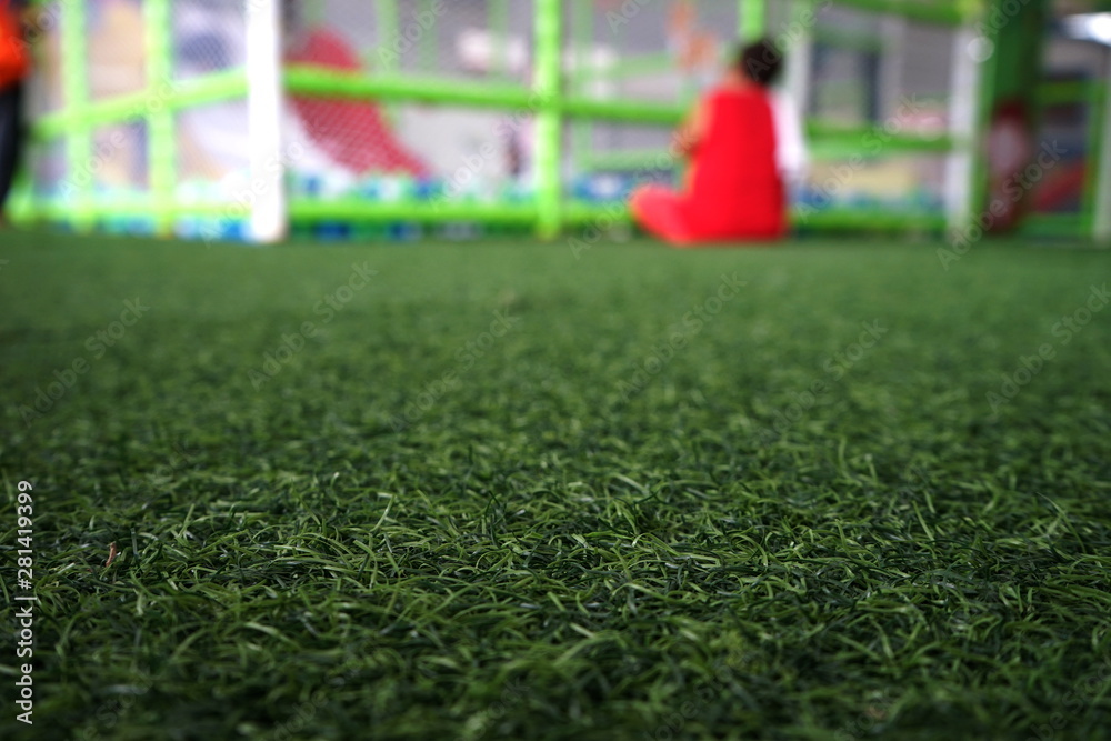 Fototapeta premium Artificial turf in the playground and blurred background