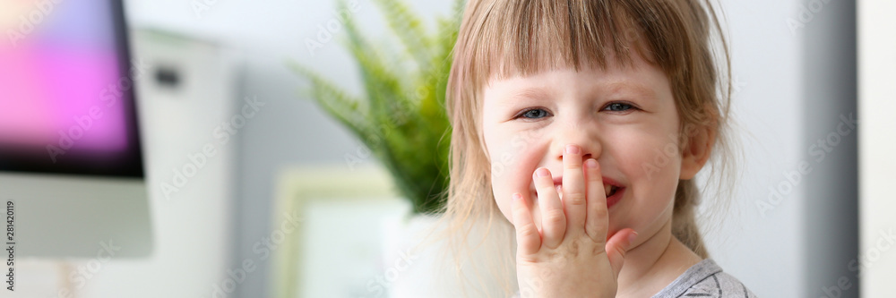 Little happy baby girl laughing covering mouth Little happy baby girl laughing covering mouth