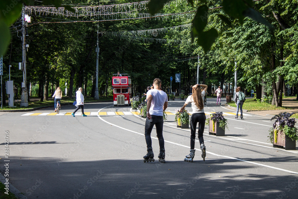 young people on roller skates on the track in Sokolniki Park in Moscow Russia