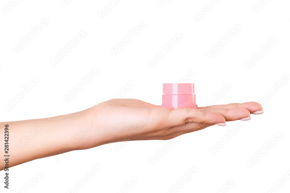 Female hand holding cream bottle of lotion isolated. Girl give jar cosmetic products on white background Female hand holding cream bottle of lotion isolated. Girl give jar cosmetic products on white background