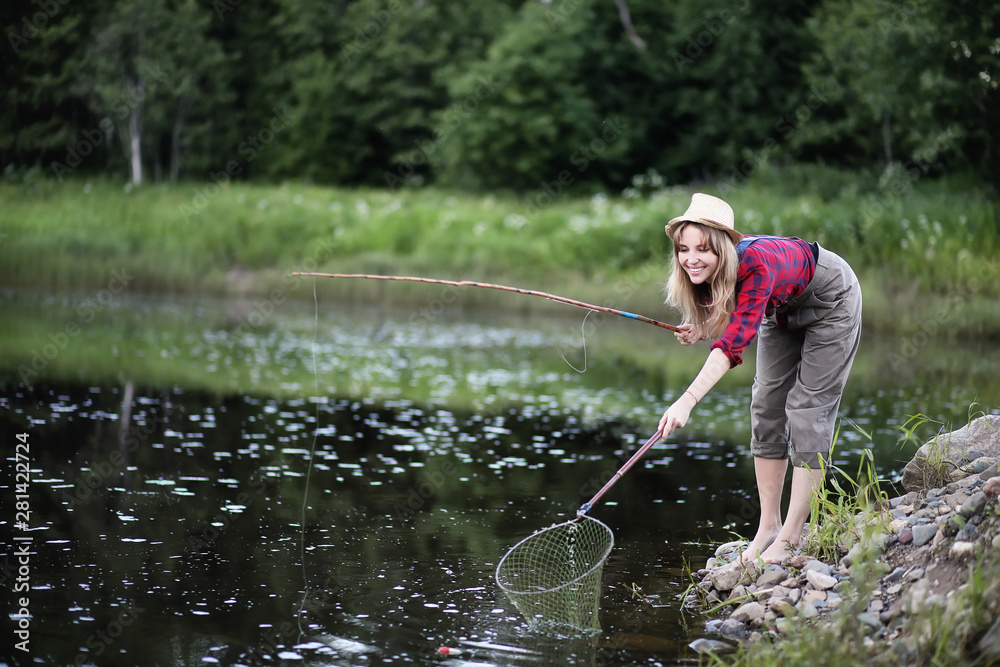 Girl by the river with a fishing rod Girl by the river with a fishing rod
