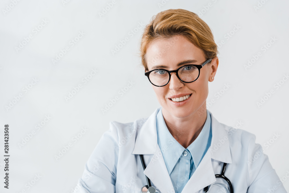 beautiful doctor in glasses looking at camera while smiling in clinic beautiful doctor in glasses looking at camera while smiling in clinic
