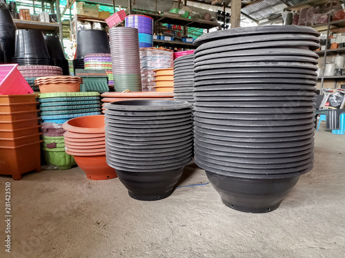 Colorful of plastic flower pot on wooden table in Agriculture shop..