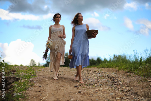 Two girls in dresses in summer field © alexkich