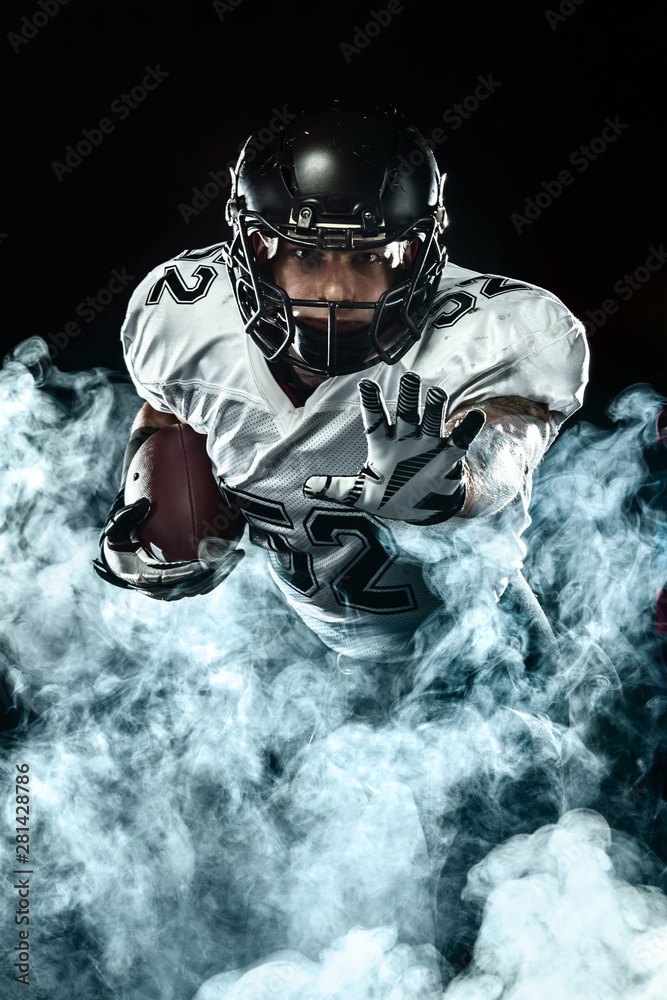 American football sportsman player in helmet on black background with  smoke. Sport and motivation wallpaper. Stock Photo | Adobe Stock