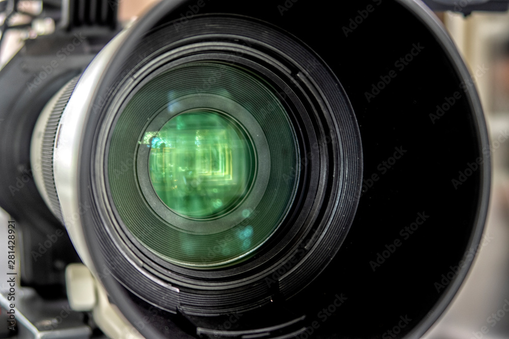 close up of a television lens on a dark background