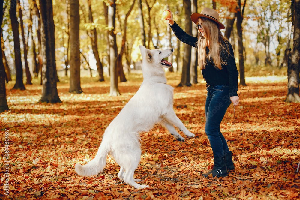 Beautiful girls in a park. Cute ladies in a stylish clothes. Girl with cute dog Beautiful girls in a park. Cute ladies in a stylish clothes. Girl with cute dog