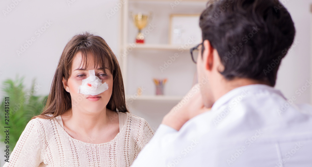 Male doctor talking to patient with nose operation surgery Male doctor talking to patient with nose operation surgery