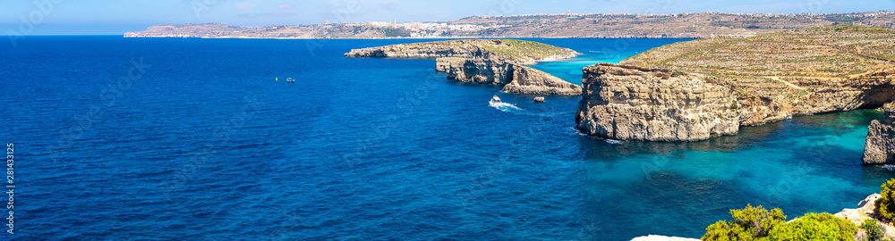 Stone cliffs on the blue lagoon of the island of Comino and Gozo Malta. Mediterranean Sea