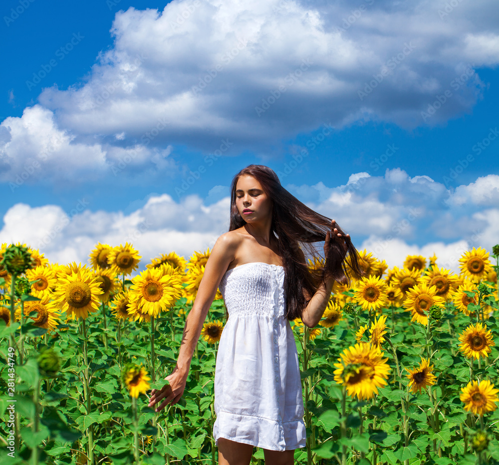 Portrait of a young beautiful girl in a field of sunflowers Portrait of a young beautiful girl in a field of sunflowers