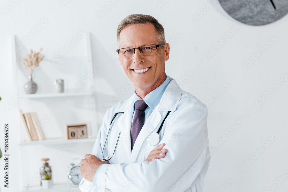 happy doctor in white coat and glasses with crossed arms happy doctor in white coat and glasses with crossed arms