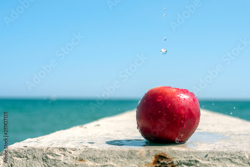 Red apple on the background of the sea