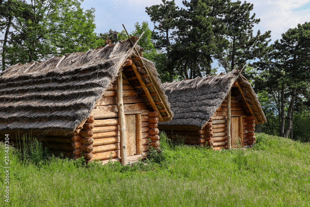 Historic Slavic dwelling on the Molpir hill in the Little Carpathians. Two wooden cottages with straw roof on the hillfort. Historic Slavic dwelling on the Molpir hill in the Little Carpathians. Two wooden cottages with straw roof on the hillfort.