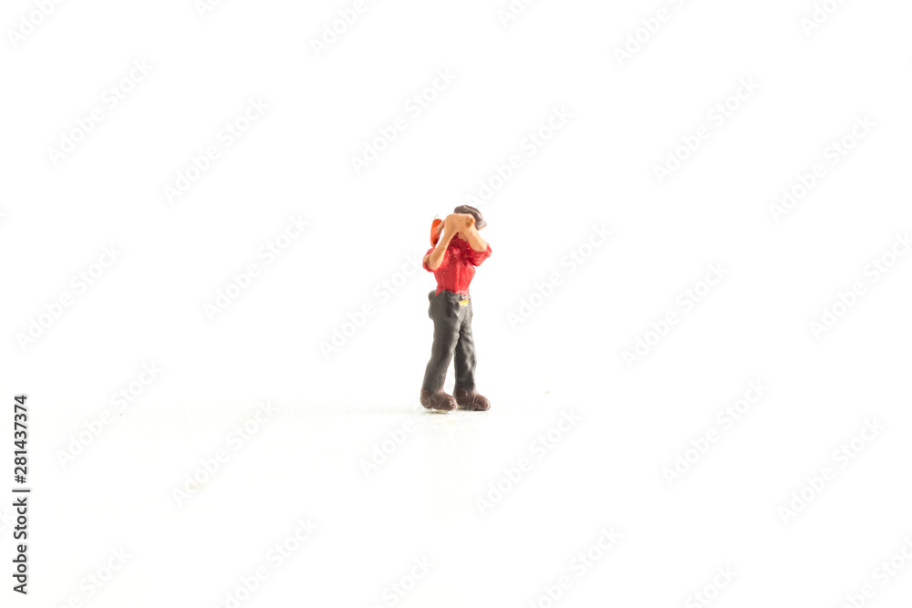 Miniature Person wearing a red shirt while holding an axe standing on a White Isolated Background Miniature Person wearing a red shirt while holding an axe standing on a White Isolated Background