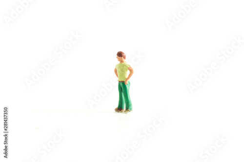 Miniature person with there hands on there hips on a white isolated background