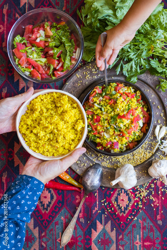 Tabbouleh - Arabic salad with bulgur and couscous, parsley, tomatoes, onion, lemon. Family have, eats Arabic traditional food. photo