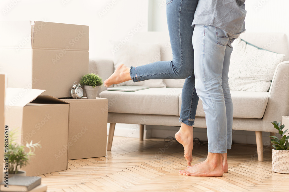 Happy Man Lifting Woman Among Moving Boxes In New House Happy Man Lifting Woman Among Moving Boxes In New House