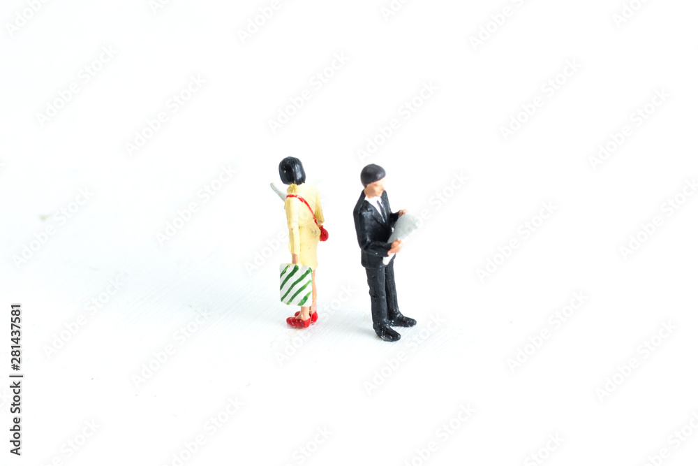Miniature People Looking at Media/Newspaper/Phone Standing on a White Isolated Background Miniature People Looking at Media/Newspaper/Phone Standing on a White Isolated Background