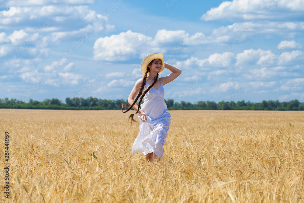 Young brunette woman in white dress walking in a wheat field Young brunette woman in white dress walking in a wheat field