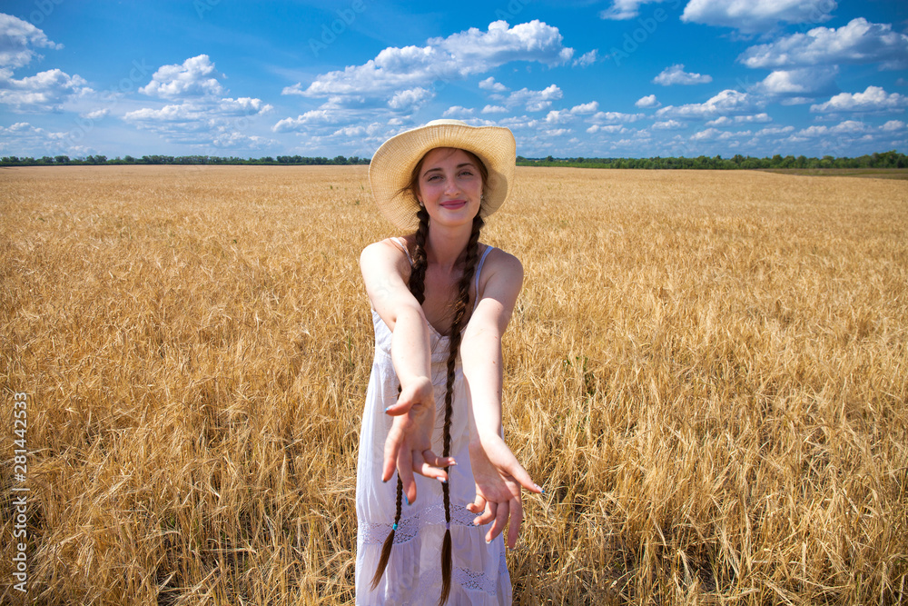 Naklejka premium Come with me, young beautiful girl holds the hand of a man in a wheat field