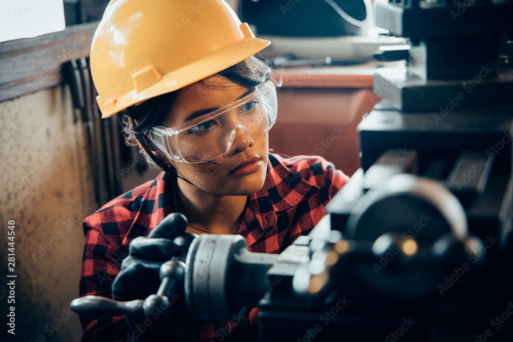 Asian beuatiful woman working with machine in the factory engineer and working woman concept or woman day - obrazy, fototapety, plakaty 