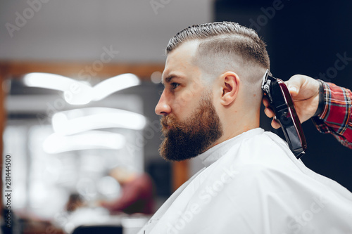Hairdresser with a client. Man with a beard. Guy in a barbershop photo