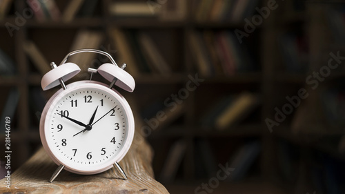 Close-up of a alarm clock on wooden desk