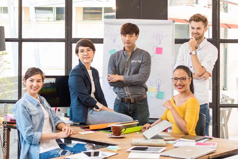 Group of five creative worker brainstorm together in office, new style of workspace, relax scene of people in office Group of five creative worker brainstorm together in office, new style of workspace, relax scene of people in office