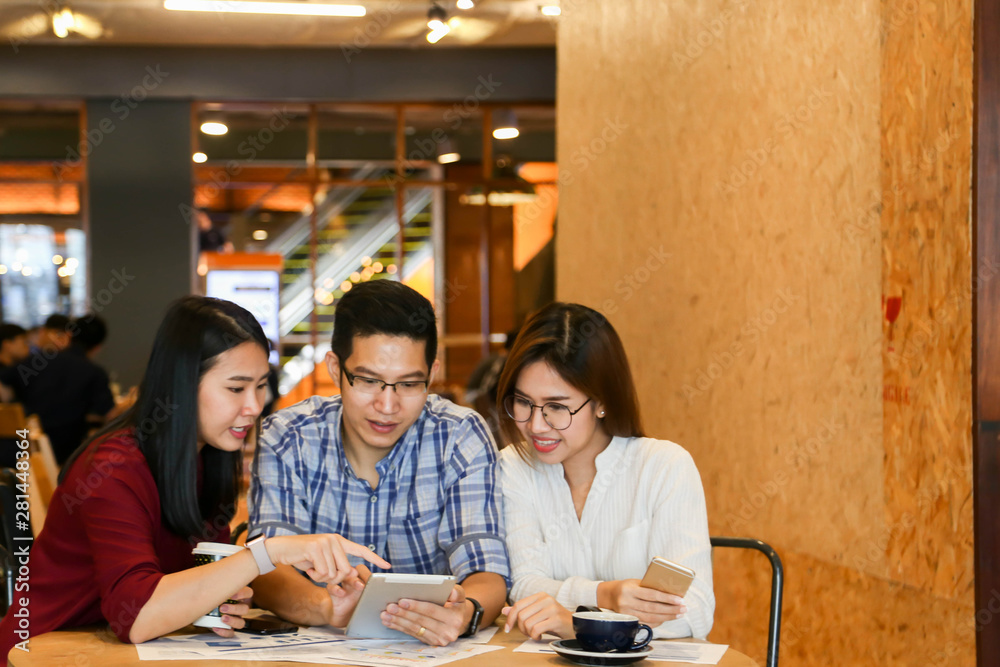Group of three casual business meeting to discuss ideas and laptop on table in coffee shop. Group of three casual business meeting to discuss ideas and laptop on table in coffee shop.