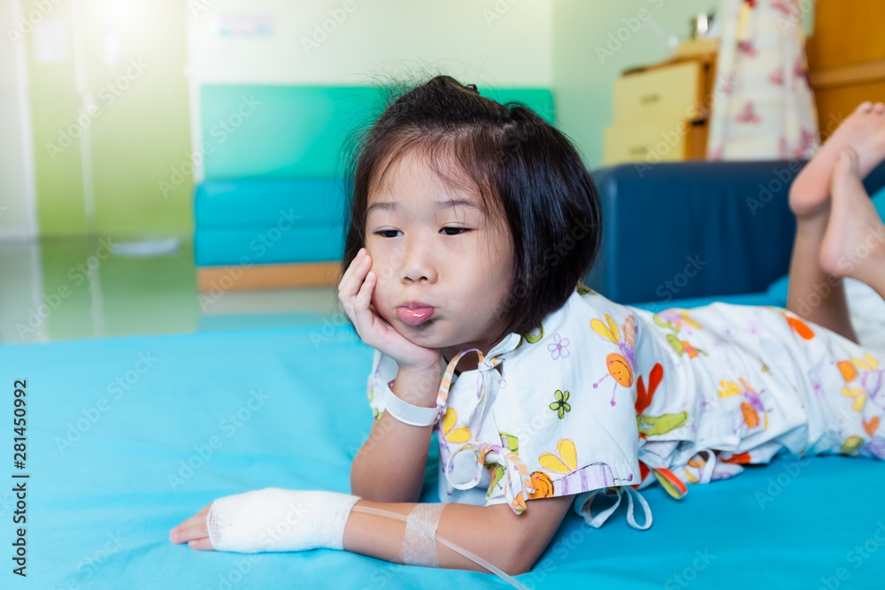 Illness asian child admitted in hospital with saline intravenous on hand. Illness asian child admitted in hospital with saline intravenous on hand.