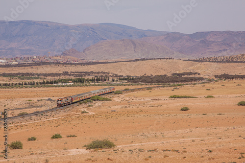 Passenger train in desert valley