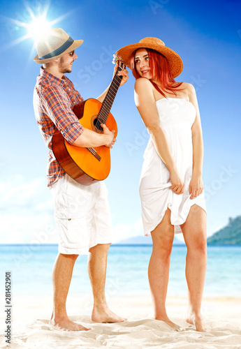 Happy woman and man having fun on the beach on sunny summer day. © magdal3na