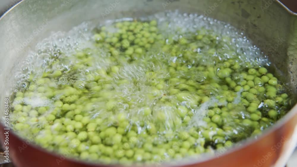 A female chef boiling Japanese sansho (peppercorn) at home kitchen, Tokyo, Japan. May 2019. Camera fixed, extreme close-up, high angle. A female chef boiling Japanese sansho (peppercorn) at home kitchen, Tokyo, Japan. May 2019. Camera fixed, extreme close-up, high angle.