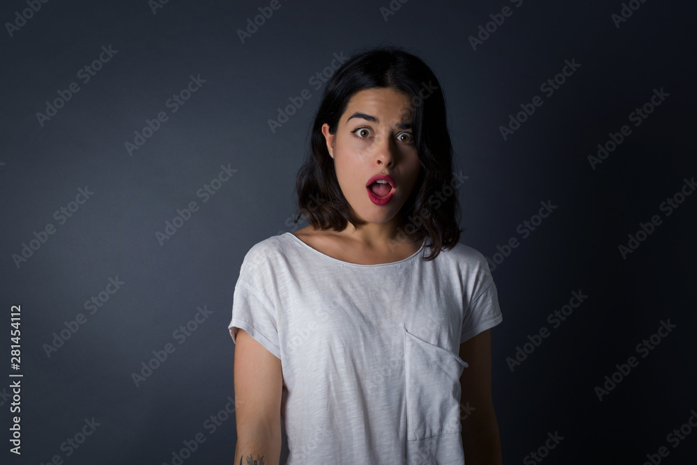 Attractive young woman having stunned and shocked look, with mouth open and jaw dropped, listening to friend's story in full disbelief, exclaiming: Wow, I can't believe this. Surprised girl. Shock Attractive young woman having stunned and shocked look, with mouth open and jaw dropped, listening to friend's story in full disbelief, exclaiming: Wow, I can't believe this. Surprised girl. Shock